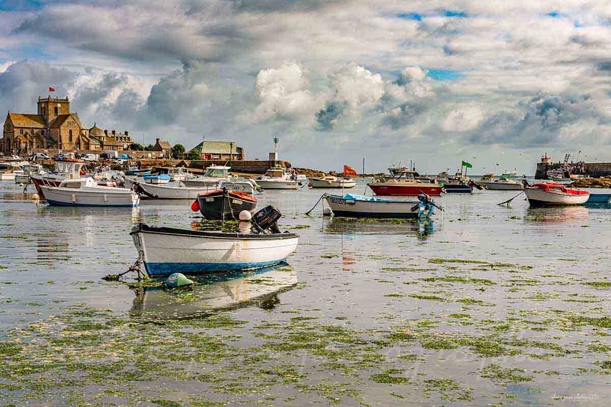Photographie du port de Barfleur avec ses bateaux, en Normandie, en fond un ciel nuageux extraordinaire.