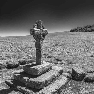 Photographie de la croix de la Rode, en Lozère, Aubrac. En noir et blanc très contrasté.